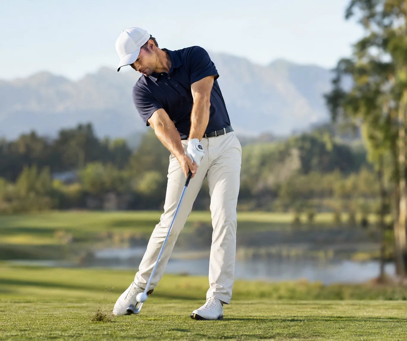 A realistic golfer at the moment of impact, weight clearly shifted onto the lead foot, hands ahead of the golf ball, solid balanced posture, lush fair...